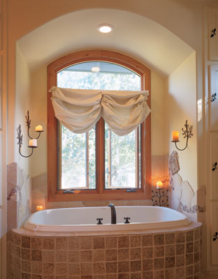 
As Marvin windows (www.marvin.com) open the master bathroom to natural light, natural fiber window coverings provide privacy and shade from the Texas sun. The bathroom is tiled with American Tile, laid by Dennis Bruhn, a local craftsman.
